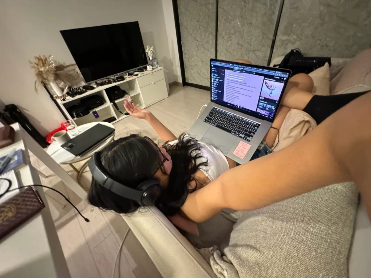 Cercie studying on the floor with headphones and her laptop