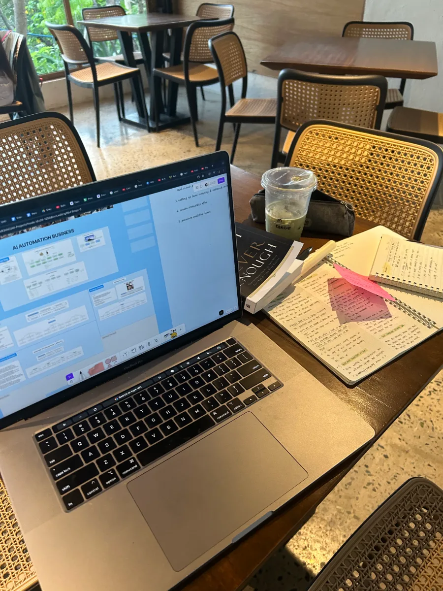 An automation workflow open on a laptop at a cafe table